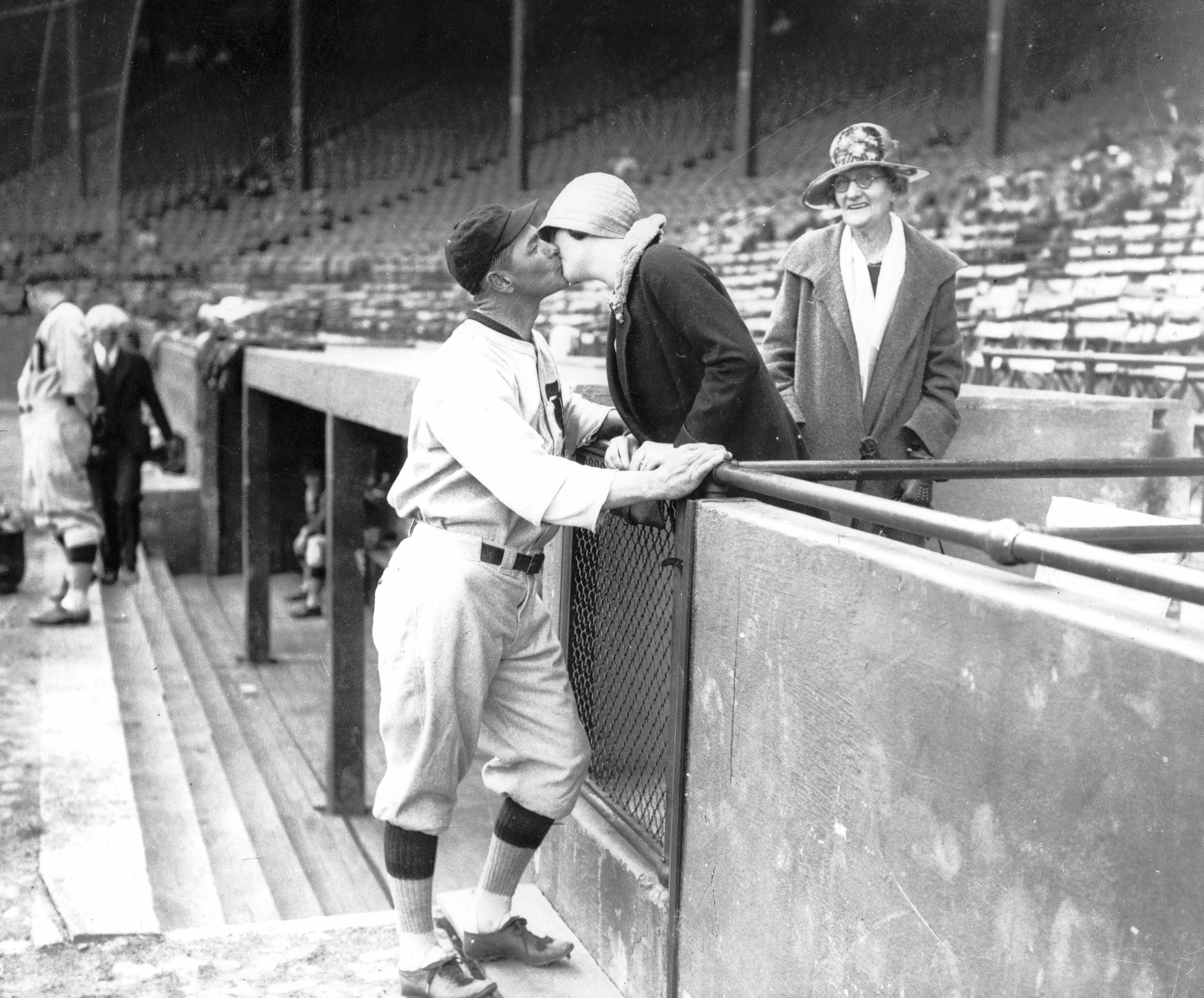 Unidentified baseball player and woman kissing, 1928 ca.