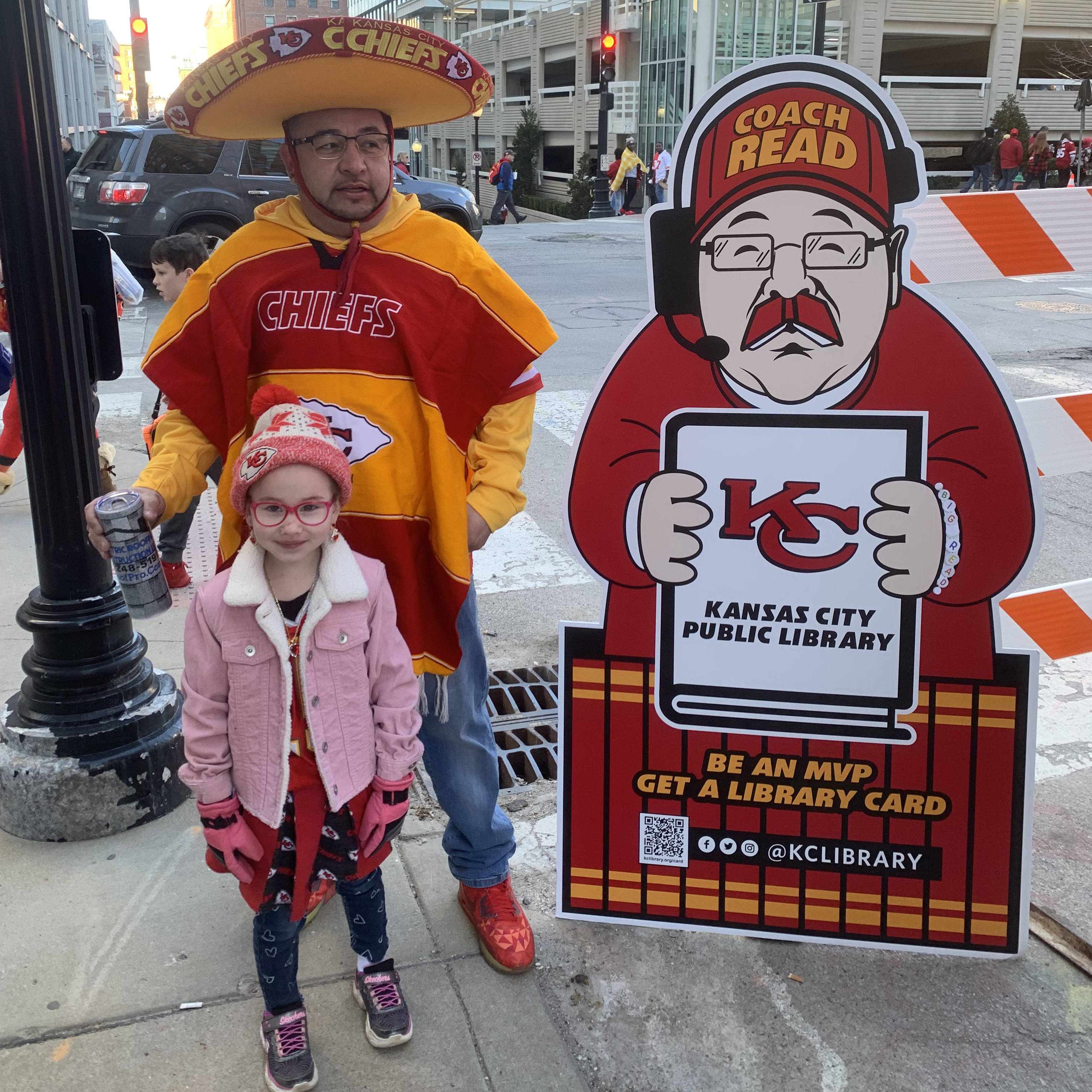 man and child by cardboard cutout