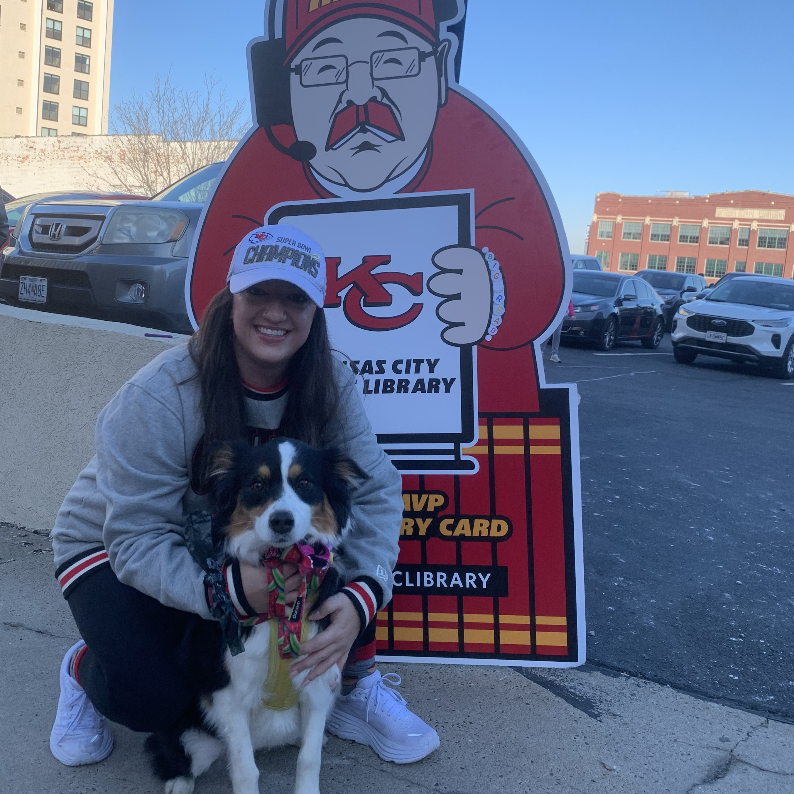 woman and dog by cardboard cutout