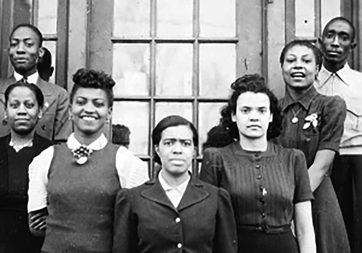 black and white photo of people in front of window