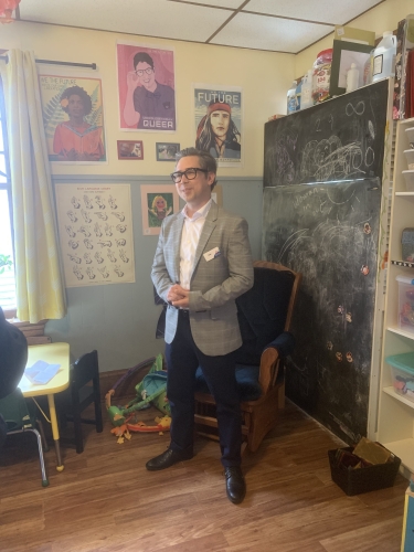 man stands in front of hung artwork