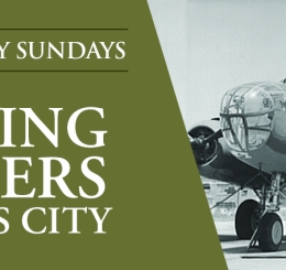 black and white photo of men loading bomber plane