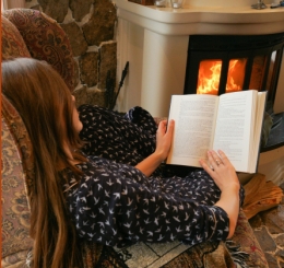 woman reading by fire