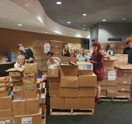 Teens with boxes of books 