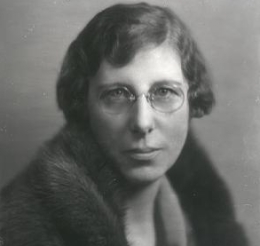 Nelle Peters wearing a fur coat. 