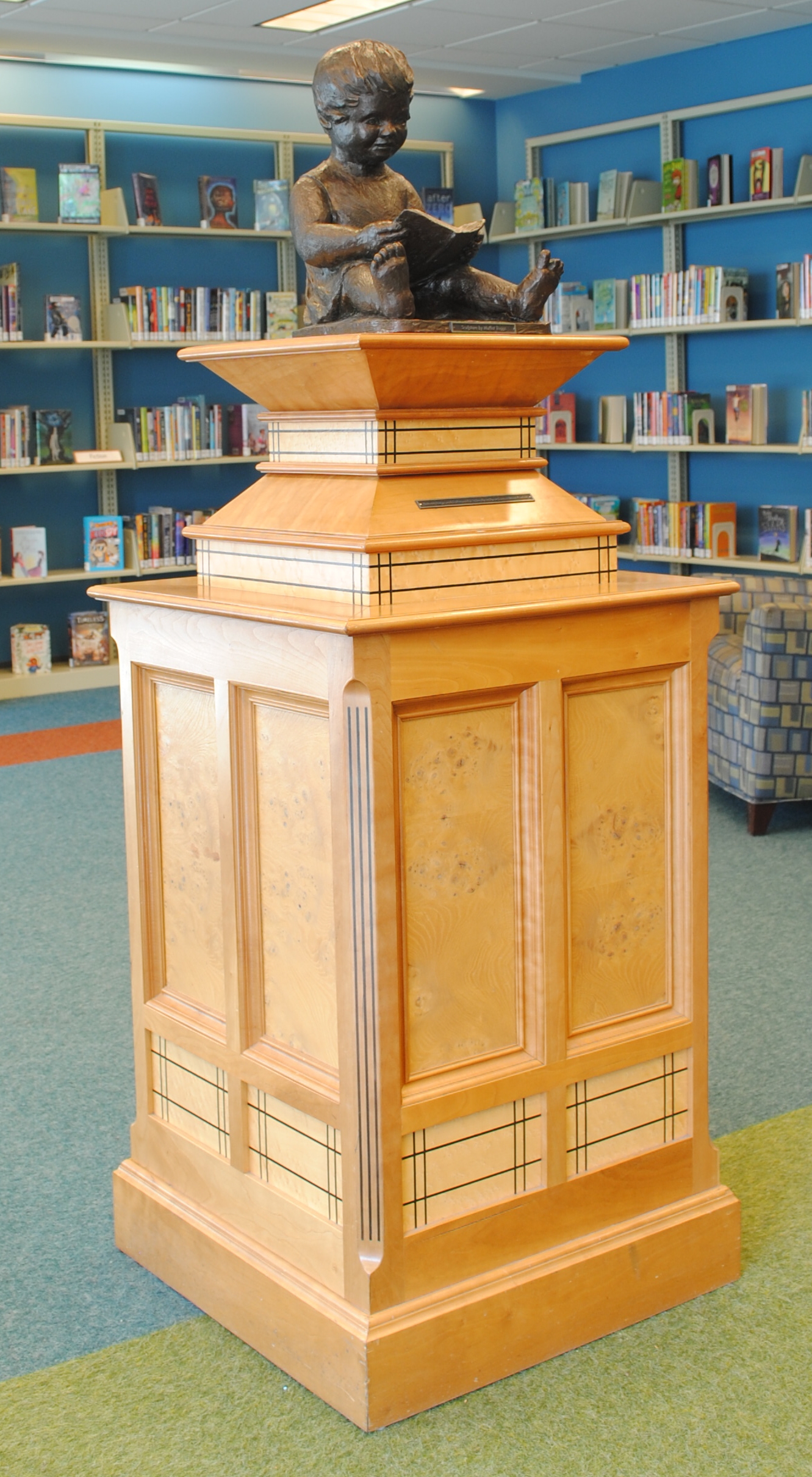 Child Reading on Pedestal