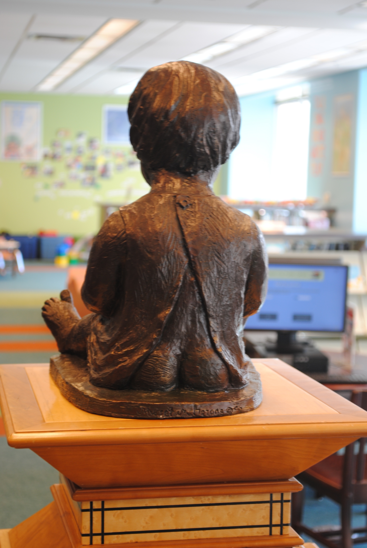 Child Reading on Pedestal