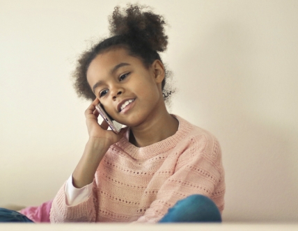 girl with pigtails on phone