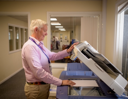 Older woman using a photocopy machine