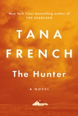 A white, two story farm house sits in a field with possible storm clouds behind. The photo itself is in an orange/yellow hue.