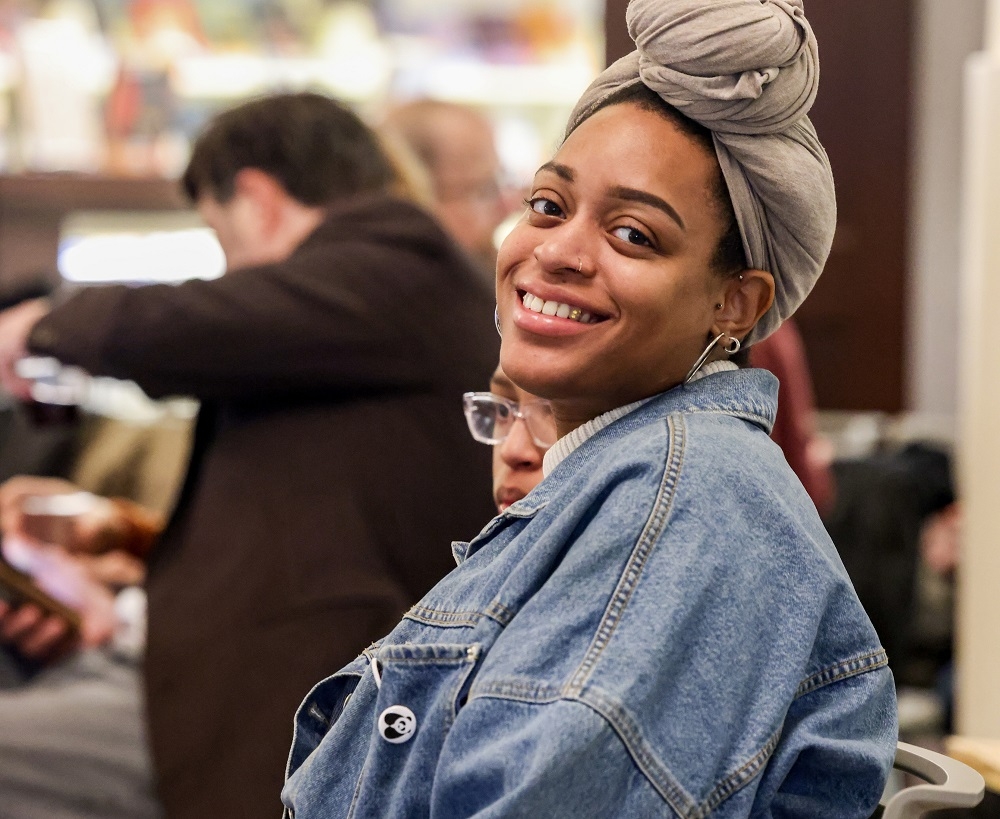 woman in chair smiles